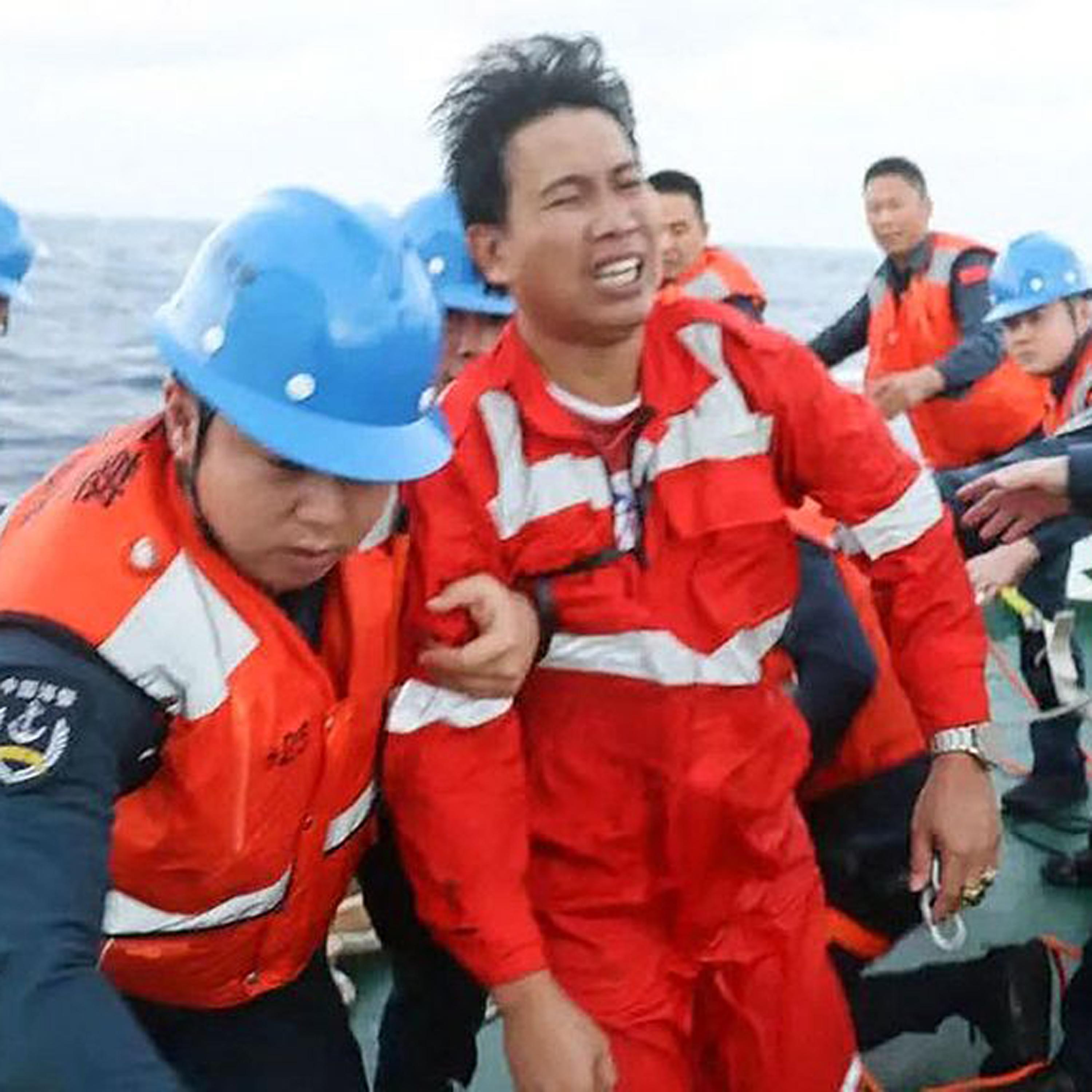 China Coast Guard transfers rescued Filipino crew after cargo ship capsizes